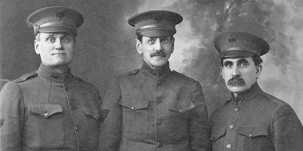 Three men in uniform.