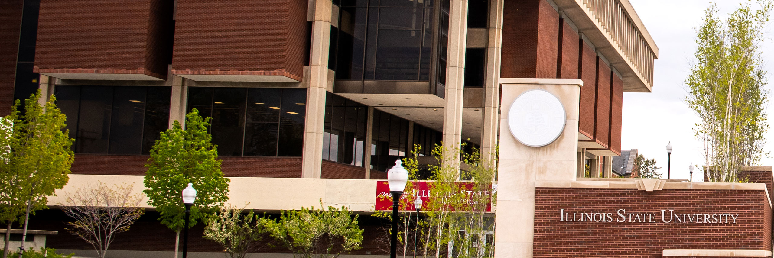 Milner Library exterior behind the ISU Seal