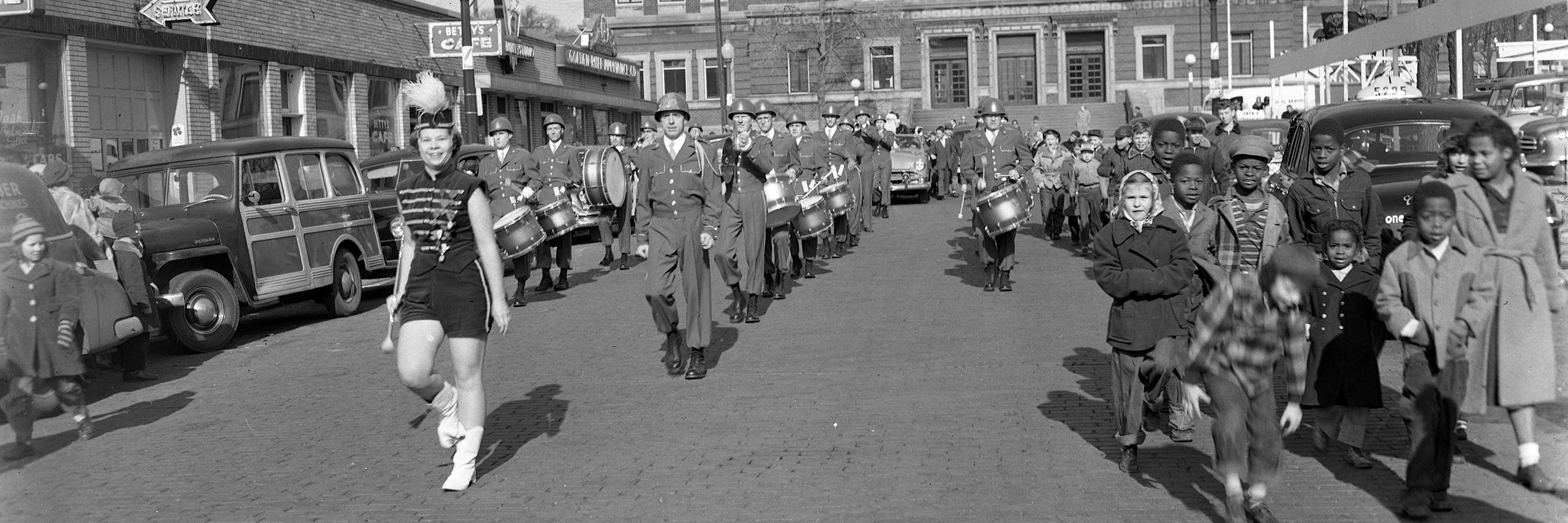 Black and white photograph of Santa Claus Parage with marching band and children