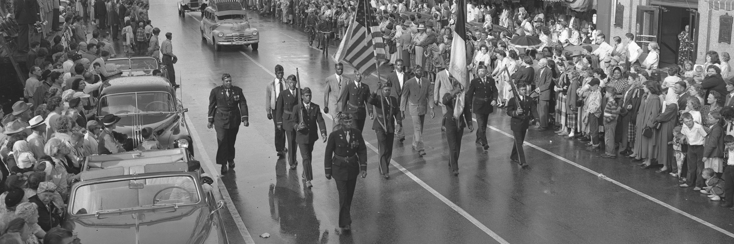 Black and white photo of military personnel marching in a parade