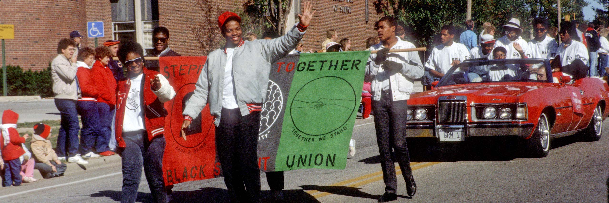 Students walking and waving in a parade