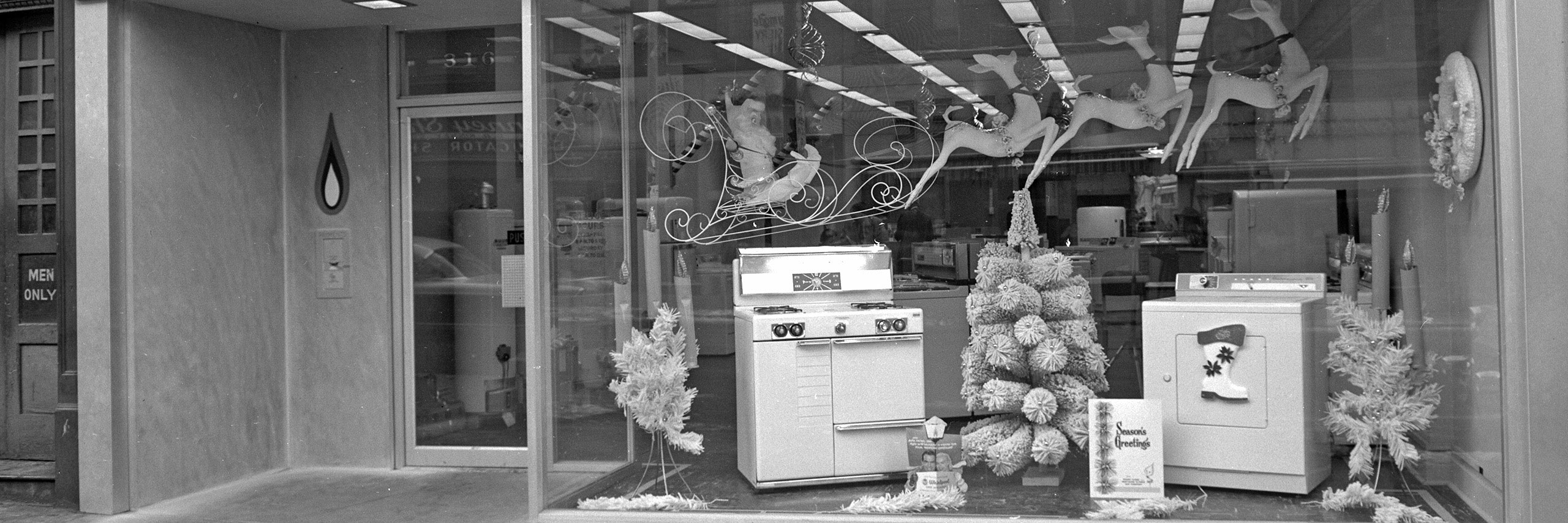 Storefront window decorated for Christmas