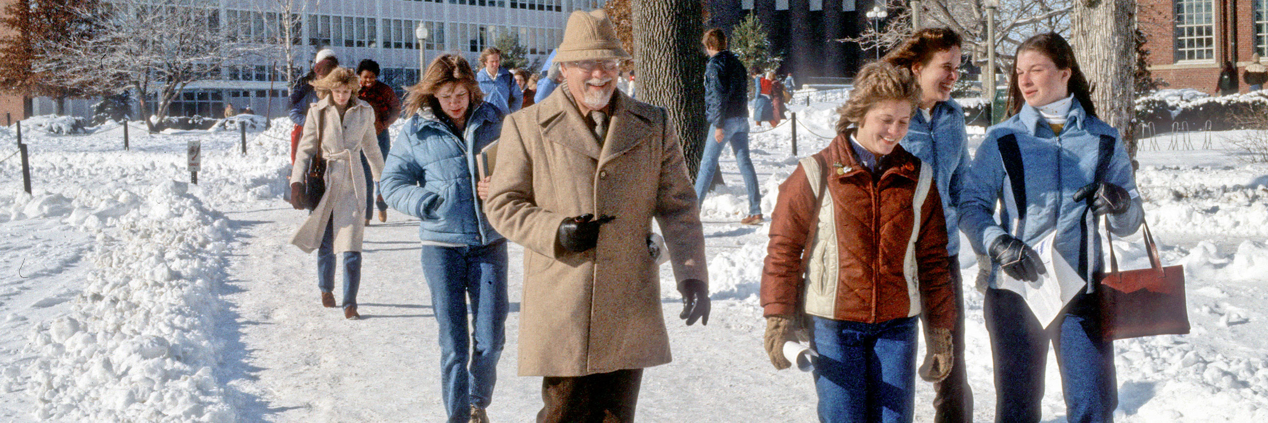 Students, faculty, and staff walking across the snow covered ISU quad.
