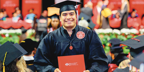 Student holding diploma during Commencement