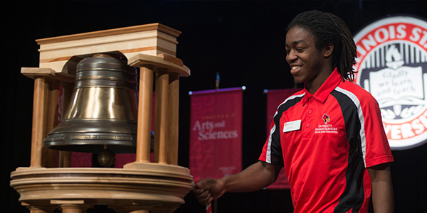 Person pulling a cord ringing the Founder's Bell