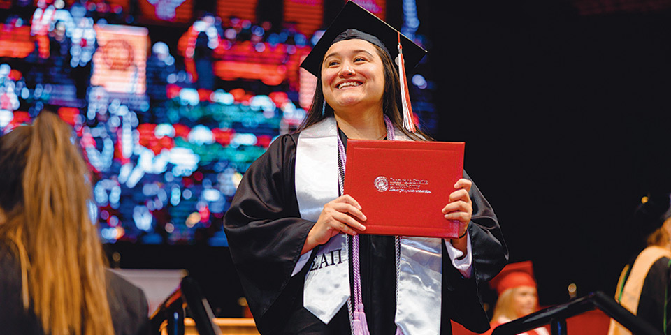 Student holding diploma during Commencement 