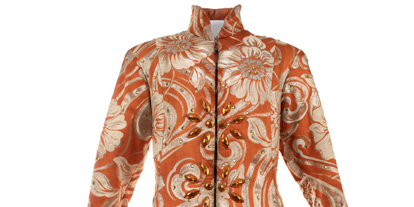 orange long-sleeved shirt with ornate flower pattern in silver