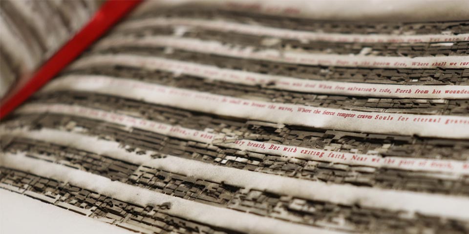 Close view of a book of sheet music with the notes burned out