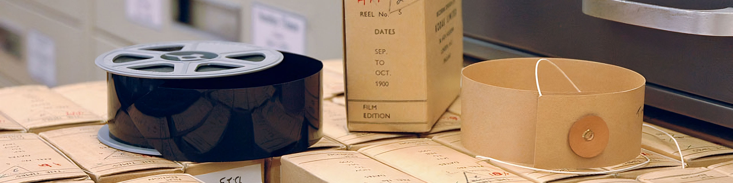 A roll of microfilm next to a refill box.