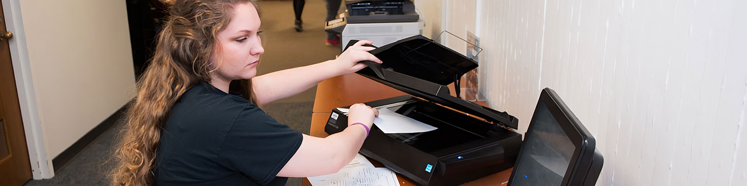 A student scanning a document in Milner.
